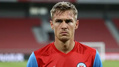 Mid-40s anonymous GIF Sundsvall coach, lean build, intense eyes, head-and-shoulders, wearing a plain red shirt with...