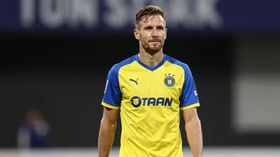 A photorealistic image of an anonymous ÖFK player in his 30s, wearing a yellow and blue jersey made of smooth fabric...